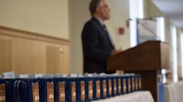 François Amar speaks at Celebration next to a table covered in Honors Steins.