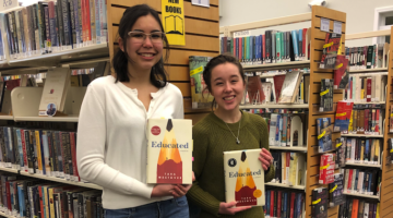 First-year Honors students Rebecca Collins and Elaine Thomas hold their copies of the book Educated in the Orono Public Library