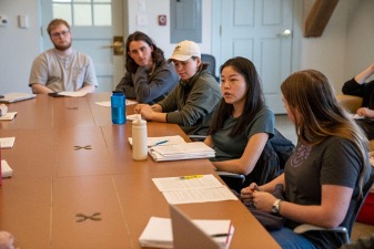 A group of students discussing in an Honors Course