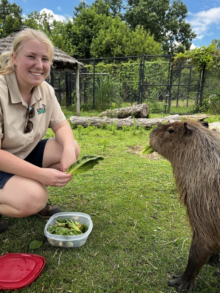 A photo of a student with an animal.