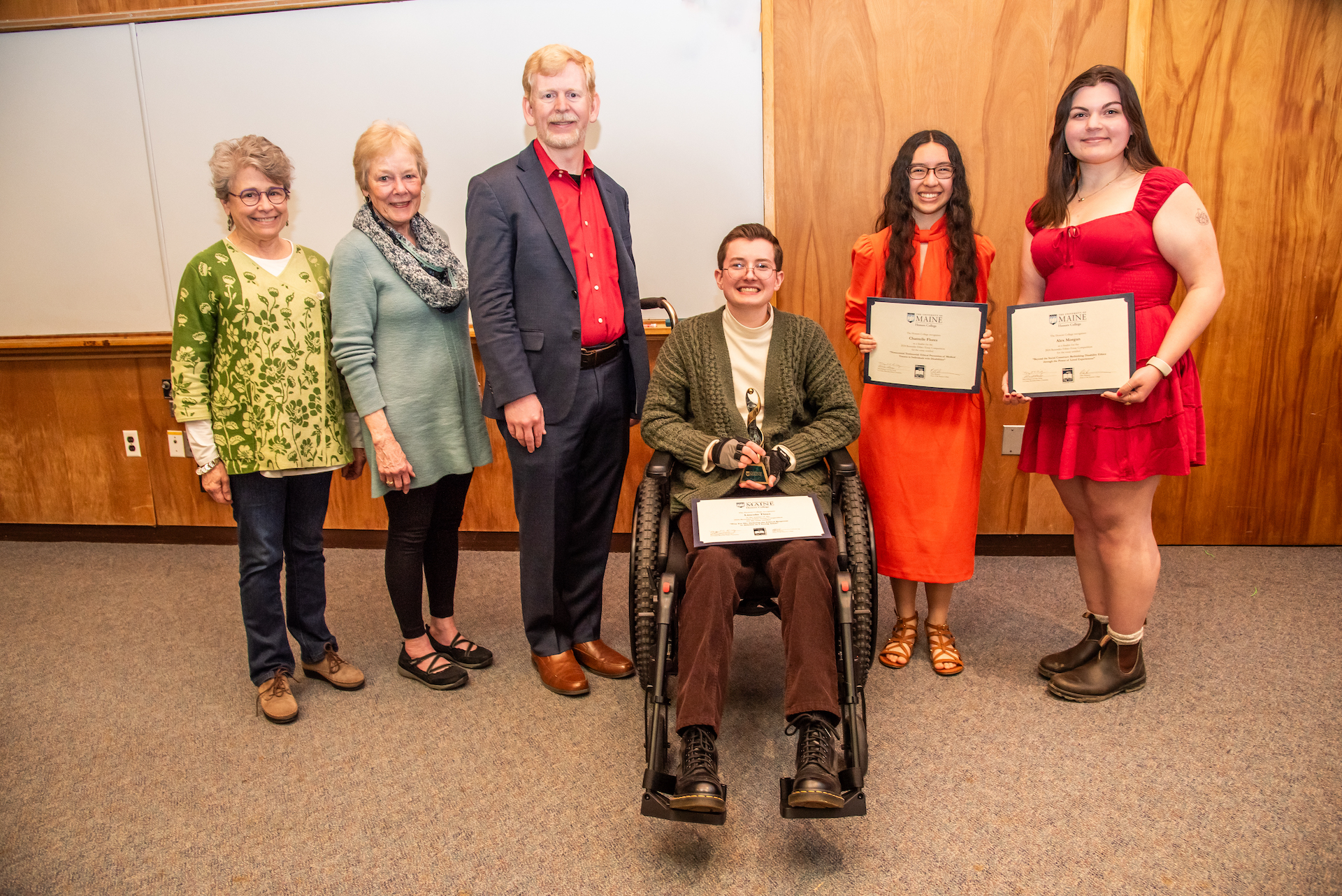 A photo of Lincoln Tiner, the winner of the 2024 Rezendes Ethics Essay Competition, along with the Rezendes sisters, Dr. Cureton, and the 2nd and 3rd place winners.
